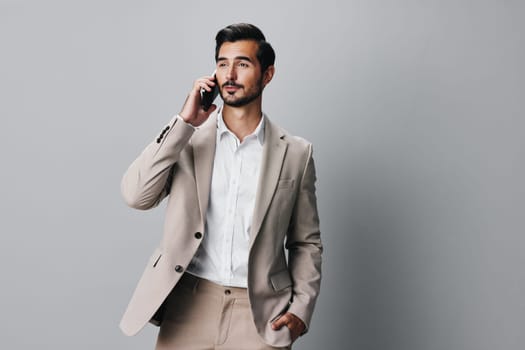 man hold internet smartphone phone businessman smile portrait message call business cyberspace suit holding beige application young isolated connection entrepreneur happy