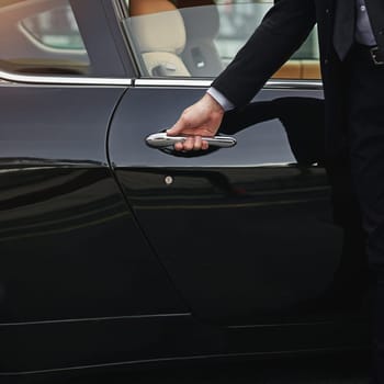 Businessman, hands and chauffeur by car door for taxi, travel accommodation or driver to commute. Hand of male person on vehicle handle in professional transport service, business class or pick up.