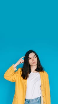 Intelligent Businesswoman in Thoughtful Pose Professional Woman with Pouted Lips and Scratching Head. Conceptual Image of a Clever and Mindful Business Lady. Perfect for Advertising. Blue Background