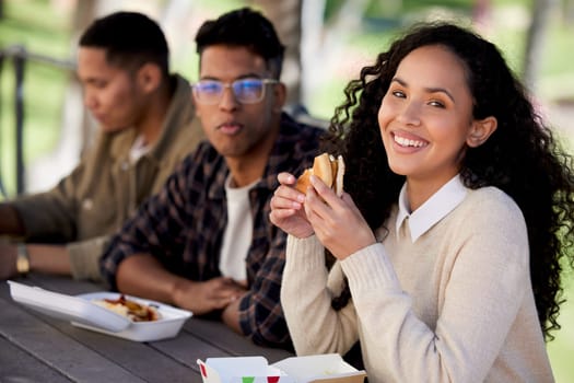 Students, smile and friends eating a burger together in university or college campus for a break meal. Happy, portrait and woman with group of young people with food, lunch or relax in a restaurant.