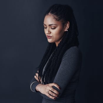 Dont let the little things get you down. Studio shot of a young woman posing against a gray background