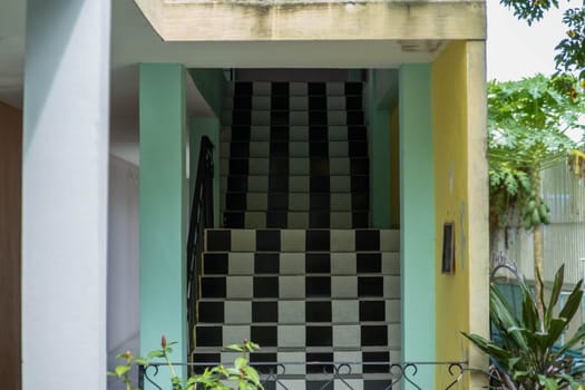 Long black and white tiled staircase in the building. building entrance stairs
