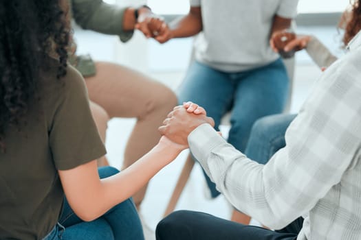 Circle, holding hands and support with praying in office for solidarity, faith and trust with religion at job. Men, woman and helping hand for prayer, team building and diversity with mindfulness.