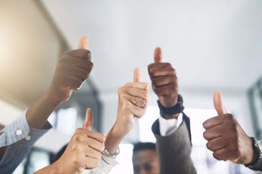 Your talents are amazing. Closeup shot of a group of businesspeople showing thumbs up in an office