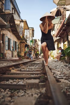 Travel enriches the mind. a woman practising yoga while out on the streets of Vietnam