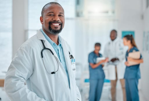 Happy, doctor and portrait of black man in hospital for medical help, insurance and trust. Healthcare, clinic team and face of professional male health worker smile for service, consulting and care.