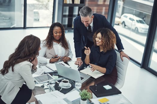 Staying on top of business operations with teamwork. a group of colleagues having a meeting in a modern office