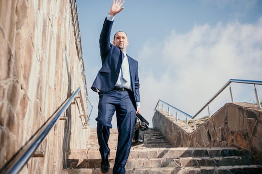 Business executive with briefcase going down the stairs.