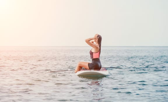 Sea woman sup. Silhouette of happy young woman in pink bikini, surfing on SUP board, confident paddling through water surface. Idyllic sunset. Active lifestyle at sea or river. Slow motion