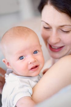 Happy, care and portrait of a mother with a baby for bonding, love and happiness. Smile, caring and a mom holding and embracing a newborn child for childcare, motherhood and parenting in a house.