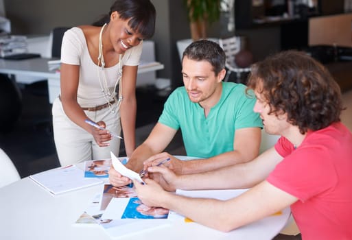 Diversity, colleagues planning and at desk in a modern workplace office together for support. Collaboration or teamwork, ideas or strategy and coworkers brainstorming or planning at workstation.