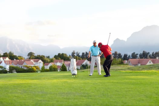 Golf course, stroke and training on the course, field or men in professional, golfer sports club and exercise on the grass. Friends, businessman or healthy game or competition on the green turf.