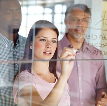 People in brainstorming meeting, writing notes on glass for creative business project at digital marketing startup and teamwork. Woman team leader, collaboration and strategy with market research.