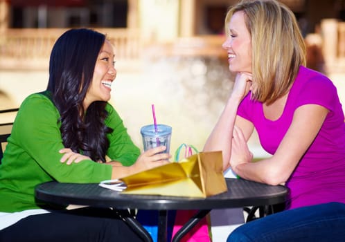 Happy, talking and women at a cafe for drinks, lunch or conversation for bonding. Smile, table and diversity with friends speaking while at a coffee shop for communication, breakfast or brunch.