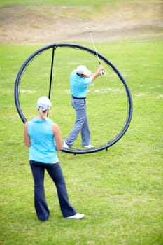 Ring, woman or beginner golfer in golf course lesson for fitness, workout or exercise with a swing on field. Coaching, golfing game or athlete training with instructor for driving with a club stroke.