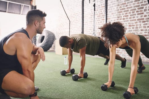 When we feel like quitting, he reminds us why we started. two people working out with a fitness instructor at the gym