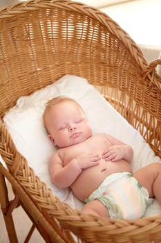 Baby, newborn or boy sleeping on bed for peaceful rest, health or nap for growth development at home. Morning, asleep or tired male infant in bedroom with fatigue resting in a quiet and calm in house.