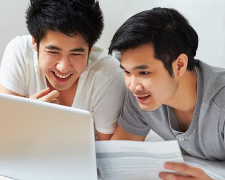 Smile, email and a gay couple with a laptop for bills, insurance or mortgage payment at home. Happy, bedroom and Asian men reading information to pay a loan with online banking on a computer.