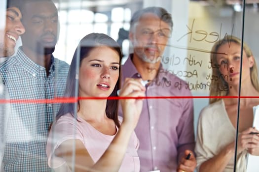 People in brainstorming meeting, writing ideas on glass for creative business project at marketing startup and teamwork. Woman team leader, collaboration and strategy plan with market research.