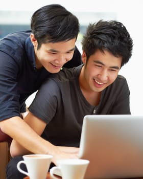 Happy, email and a gay couple with a laptop for a movie, internet search or reading web research. Smile, love and Asian men with a computer for online information, movie choice or show together.
