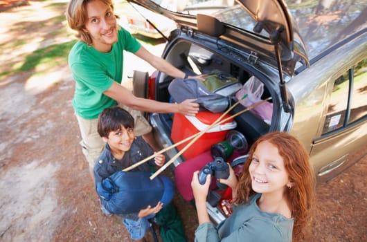 Happy family, portrait and packing car for road trip, holiday or camping vacation together in nature. Top view of father and children with smile for summer camp adventure, weekend or travel in forest.