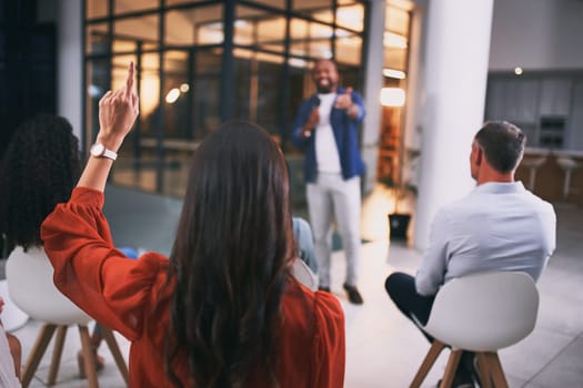 Whats your question. an unrecognizable businessperson raising their hand to ask a question during a conference at work