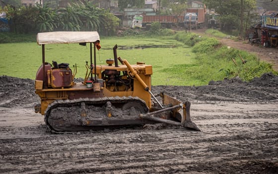 Bulldozer on road a construction site. Bardhaman West Bengal India South Asia Pacific March 23, 2023