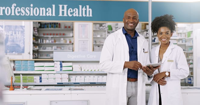 Were determined to give you top service. Cropped portrait of two pharmacists using a digital tablet together in a chemist
