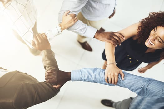 Were so strongly linked. Closeup shot of a group of businesspeople linking their arms in solidarity