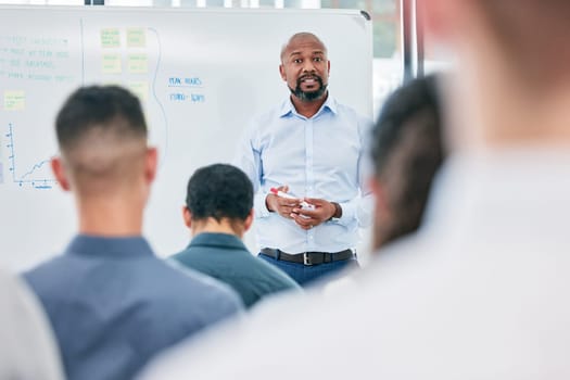 Presentation, business and speaker with audience at the office for learning about work. Conference, coach and employees are training during a meeting at a company on a board for corporate team