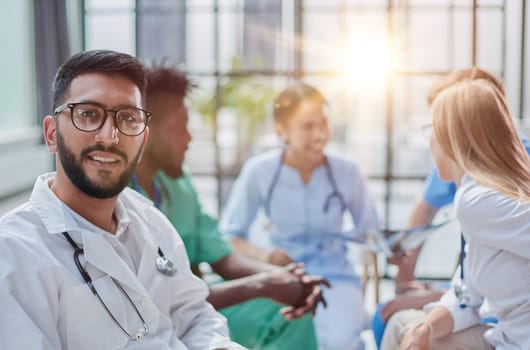 a young doctor in glasses looks at the camera