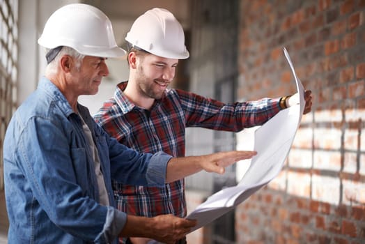 Architect team, blueprint and engineer reading for planning, analysis or real estate development. Men, paperwork and property design at construction site, building or helmet for consulting for vision.