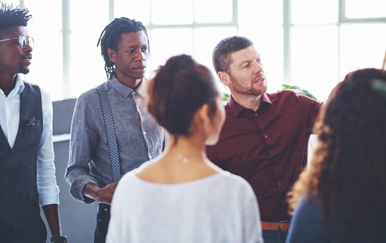 Teamwork is the only way to get things done. a group of businesspeople brainstorming in an office