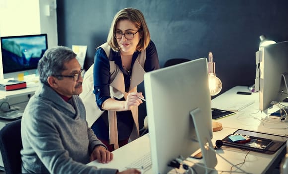 Their goal is to succeed big. two businesspeople working late in an office