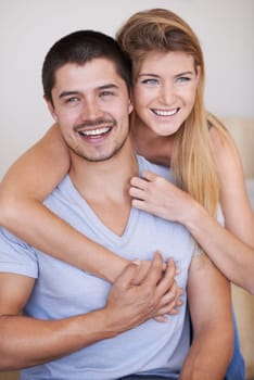 In love and feeling great. Attractive young couple relaxing together happily at home