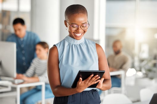 Happy, business tablet and black woman, designer or creative in coworking office. Touchscreen, technology and African female professional on email app, design research or website, internet or reading.