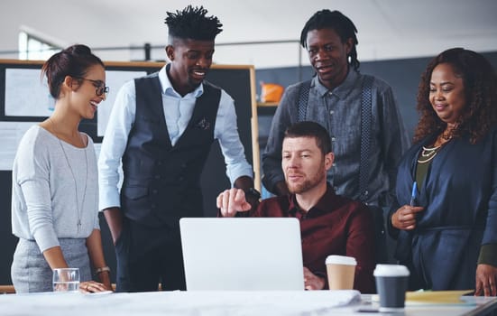 Hes got ideas to show his team. a group of creative businesspeople meeting in their office