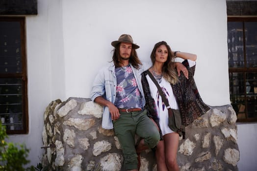 Keep calm Were hippies, were always calm. a trendy young couple standing together against the wall of a building outside