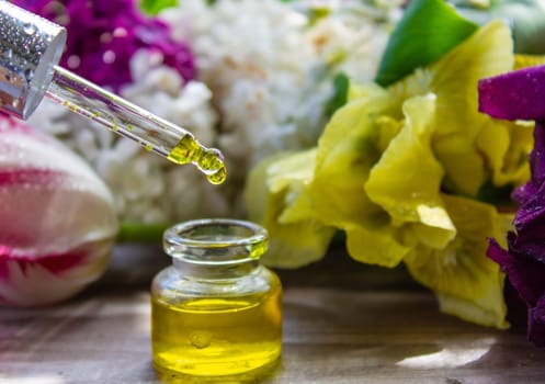 essential oil of flowers drips into a jar. selective focus. nature