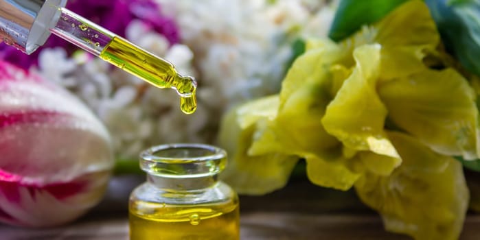essential oil of flowers drips into a jar. selective focus. nature