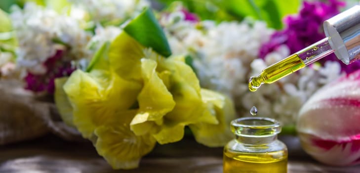 essential oil of flowers drips into a jar. selective focus. nature