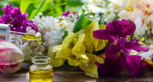 essential oil of flowers drips into a jar. selective focus. nature