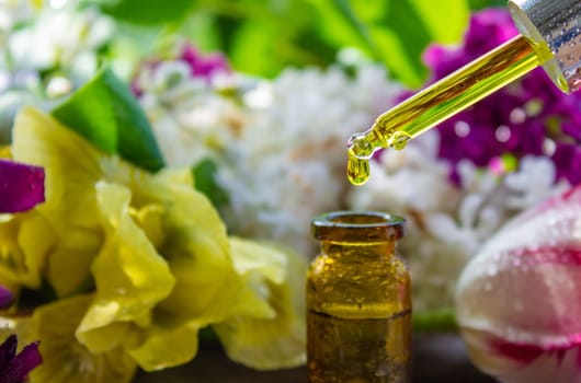 essential oil of flowers drips into a jar. selective focus. nature