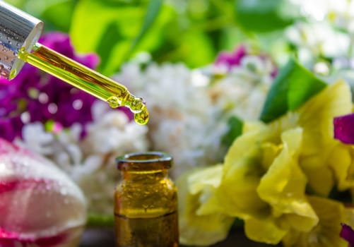 essential oil of flowers drips into a jar. selective focus. nature
