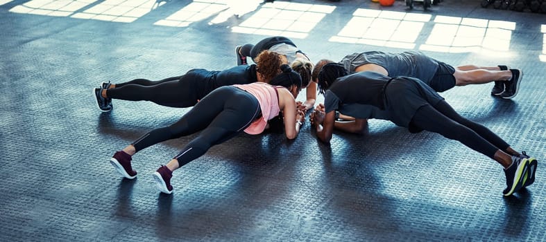 Together in this fitness journey. a fitness group having a workout session at the gym