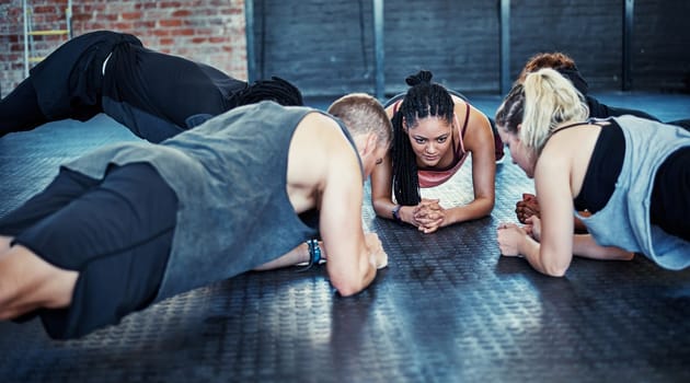 Coming together to work our bodies. a fitness group having a workout session at the gym