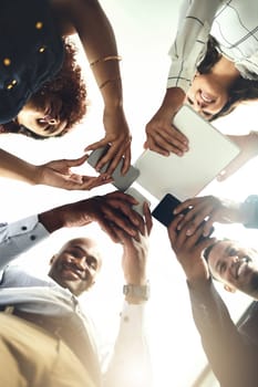 Interacting with clients all around the globe. Closeup shot of a group of businesspeople using their digital devices in synchronicity in an office