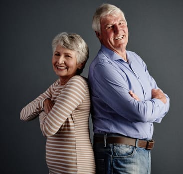 Ive got your back. Studio portrait of an affectionate senior couple posing against a grey background