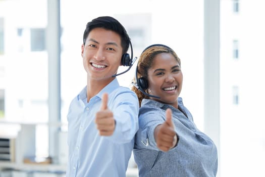 Call center, thumbs up and portrait of business people in office for teamwork, achievement and support. Customer service, target and motivation with Asian man and woman for thank you, emoji or winner.