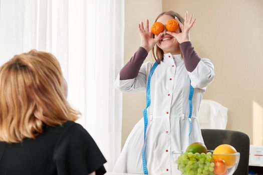 Young girl visiting nutritionist to lose weight with the help of diet program. High quality photo